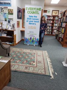 Amy stading in front of census sign