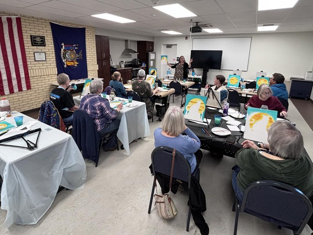 Participants enjoy a painting class inside the Tripp Community Room.