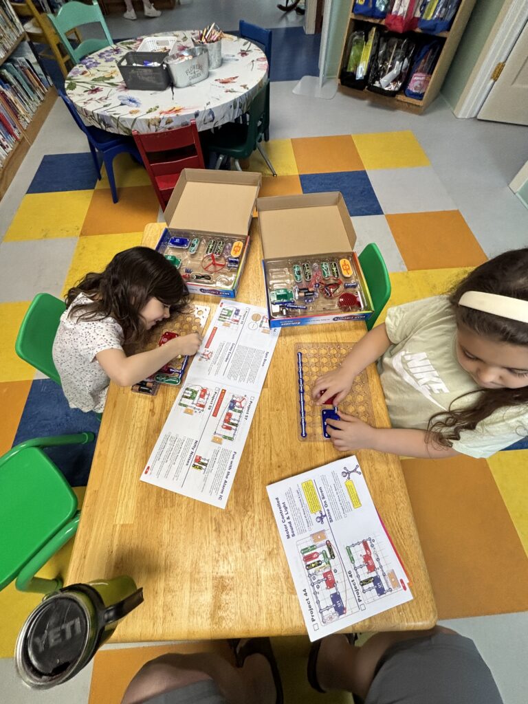 Two youth working on putting together Snap Circuit kits.